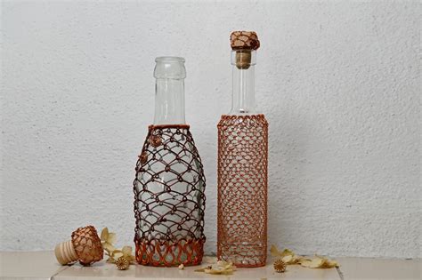 Ukážka handmade svadobných dekorácií: pierka, lampášiky, zdobené fľaše.