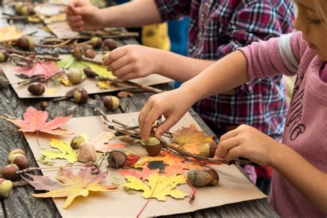 parents and children engaged in crafting autumn decorations using natural materials like leaves and fruits