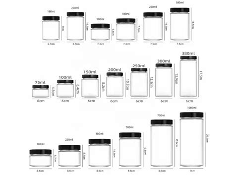 rôzne veľkosti a tvary sklenených fliaš a pohárov typu mason jar naplnené lúčnymi kvetmi ako stredové dekorácie na svadobnom stole