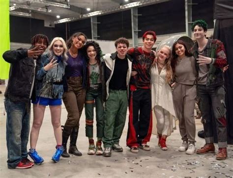 Herec v kostýme z Disneyho filmu Zombies s detailmi ako zelené vlasy a špecifické oblečenie