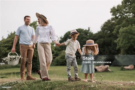 Ilustračné foto šťastnej rodiny, kde deti a otec blahoželajú matke s kyticou kvetov