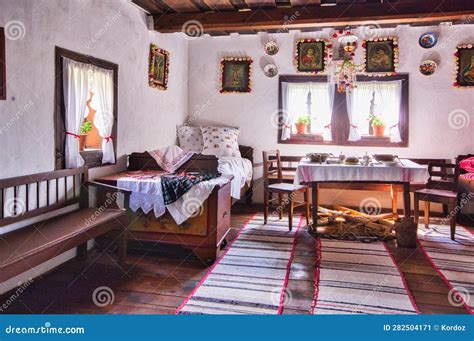 Traditional Slovak restaurant interior with wooden furniture and staff in folk costumes.
