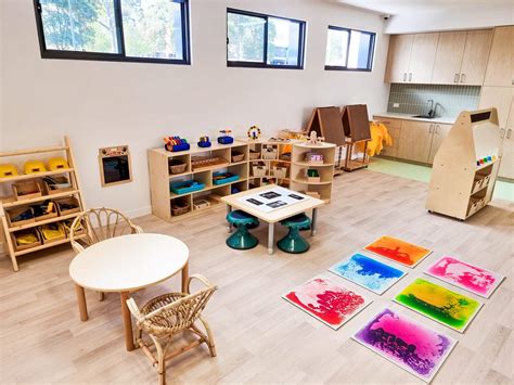 Ilustrácia zobrazujúca Montessori prostredie s nízkym nábytkom a materiálmi na dosah detí.