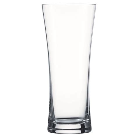 Sklenený pohár plnený vianočnými ozdobami a šiškami