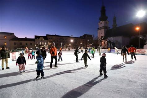 Ľudia korčuľujúci sa na ľadovej ploche na námestí