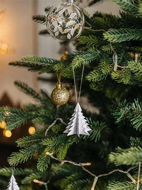 Detailný záber na vianočnú guľu s bielym trblietavým ornamentom