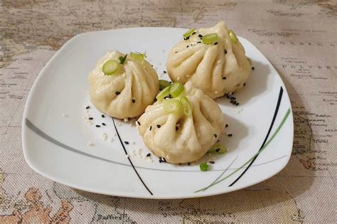 Detailný záber na tradičné červené obálky hongbao a čínske knedličky na sviatočnom stole.