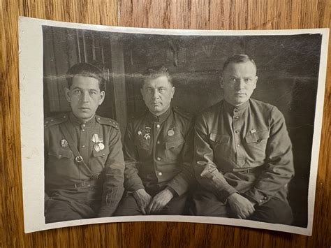 Historická fotografia skupiny vojakov z druhej svetovej vojny, stojacich bok po boku s vážnymi, ale odhodlanými tvárami