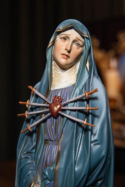 Thematic photo of Our Lady of Sorrows with seven swords in her heart, or a Pieta statue