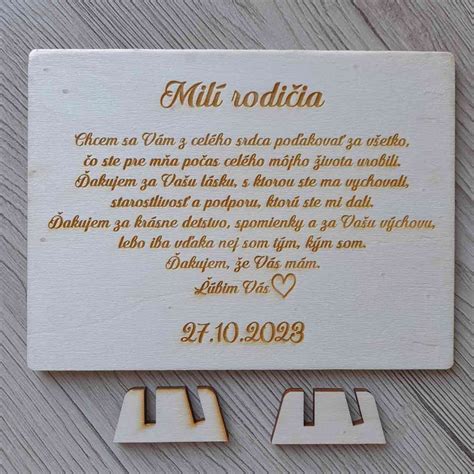 Detailná fotka vrchnáka drevenej debny s personalizovaným gravírovaným textom.