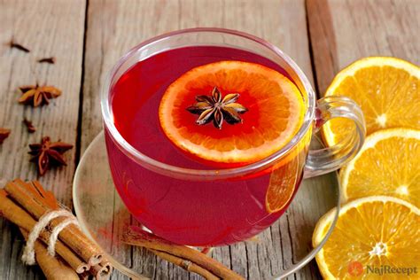Detailná fotografia hrnčeka horúceho vianočného punču s plátkami pomaranča, škoricou a klinčekmi