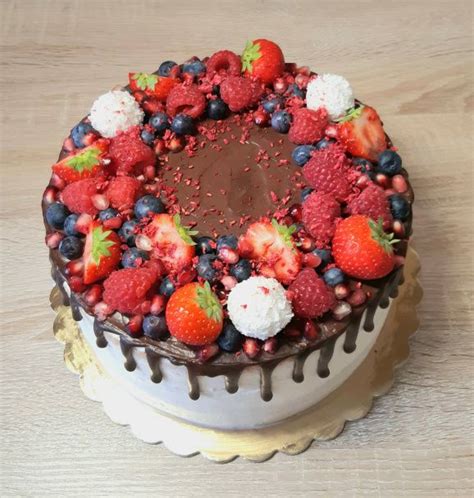 Elegantná zlatá narodeninová torta zdobená ružovými cukrovými kvetmi