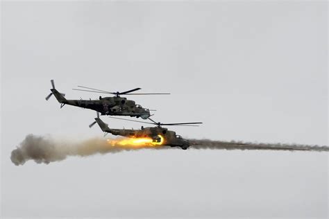 Photo of Mil Mi-24 Hind firing rockets during a live-fire exercise