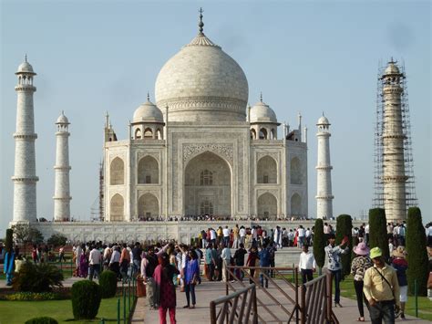 Celkový pohľad na Tádž Mahal z diaľky pri východe slnka, zdôrazňujúci menlivosť farieb mramoru