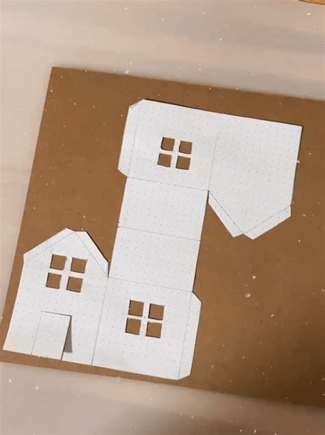 Ilustrácia papierového domčeka s podsvietenými oknami