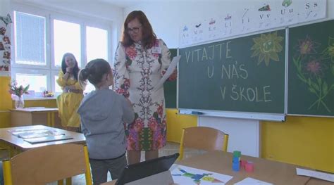 Ilustračná fotografia prvého dňa v škole s usmievavými žiakmi a učiteľmi