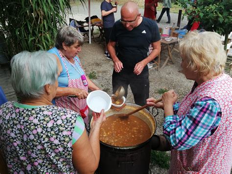 Fotografia z gulášovej súťaže s kotlíkmi a súťažiacimi