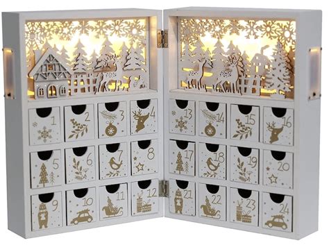 kolekcia rôznych kozmetických adventných kalendárov rozložených na sviatočne vyzdobenom stole