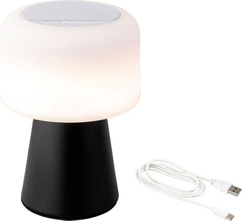Lampa s bezdrátovou nabíječkou a bluetooth reproduktorem na nočním stolku