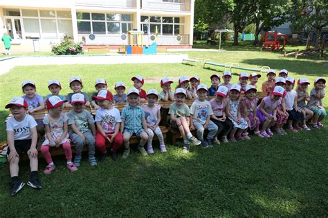 Tematická fotografia rozlúčky s predškolákmi, deti v čiapkach s rodičmi