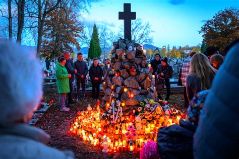 Dobová fotografia alebo ilustrácia zobrazujúca tradičnú výzdobu hrobov vencami a kvetmi počas sviatkov Všetkých svätých a Dušičiek.