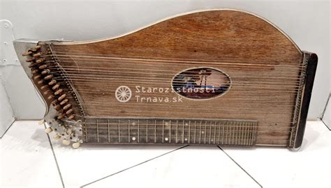 Detailný záber na hudobný nástroj (napr. gitara alebo klavír) s narodeninovou kartičkou a kyticou kvetov.