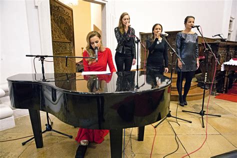 Mária Čírová pri klavíri na vianočnom koncerte, obklopená svetlami