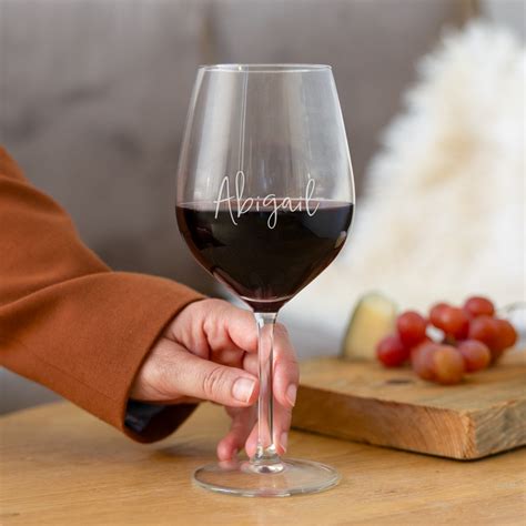 Svadobný prípitok, ruky držia poháre na víno s rozmazanými tvárami v pozadí