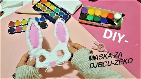Rodič s dieťaťom vyrábajúci karnevalovú masku na stole plnom materiálov