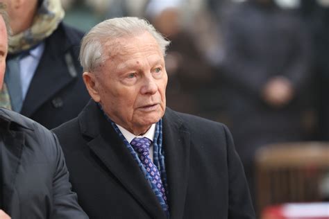Rudolf Schuster pri krste knihy, usmieva sa a drží svoju novú publikáciu