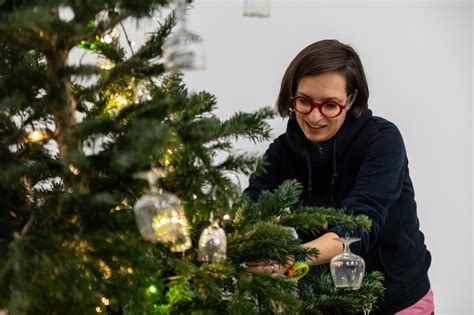 Tematické foto: Osoba zdobiaca vianočný stromček