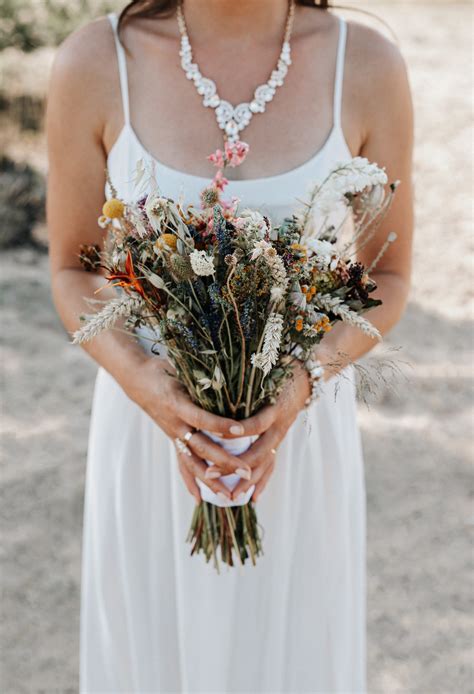 Ilustračné foto svadobných košíkov s pierkami a náramkami pre družičky v marhuľovej farbe.