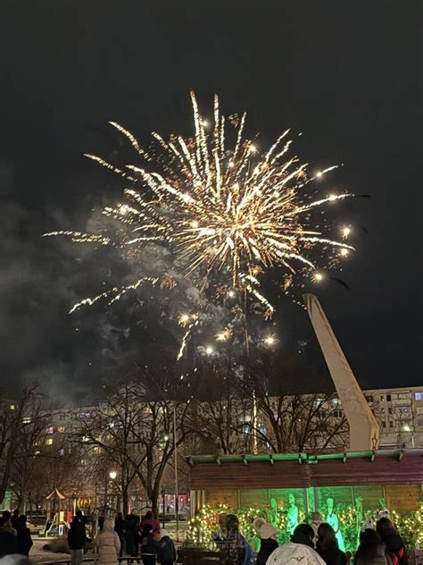 Ľudia oslavujúci Silvester na námestí s ohňostrojom