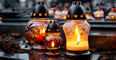 Tematické foto: Rodina zapaľuje sviečky na hrobe počas Dušičiek