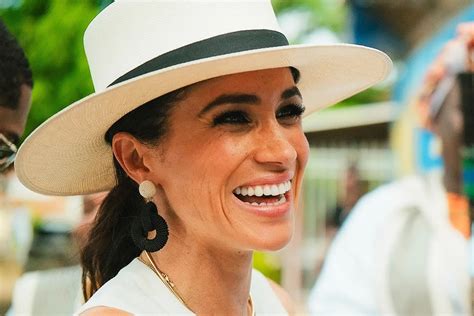 Záber z oslavy narodenín Meghan Markle, kde sfukuje sviečky na narodeninovej torte.