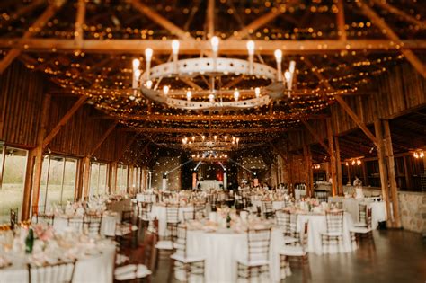 Rustikálna svadobná výzdoba v starej stodole s drevenými prvkami a jemnými svetlami